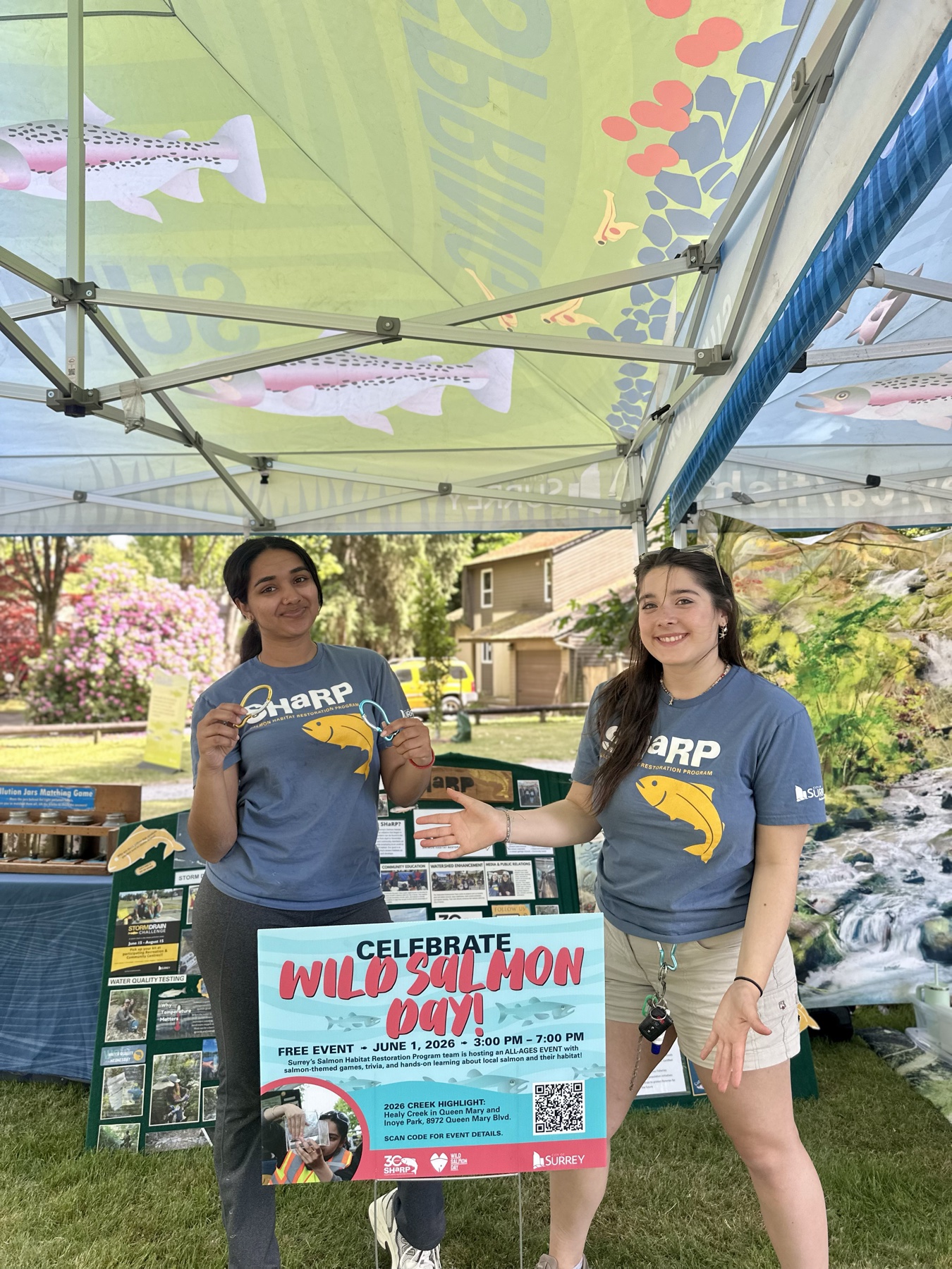 SHaRP team members welcoming visitors at a Wild Salmon Day community event